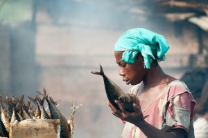 Ghanaian woman works on a fish market in Ghana