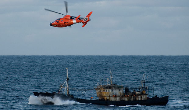United States Coast Guard patrols over illegal driftnet fishing vessel